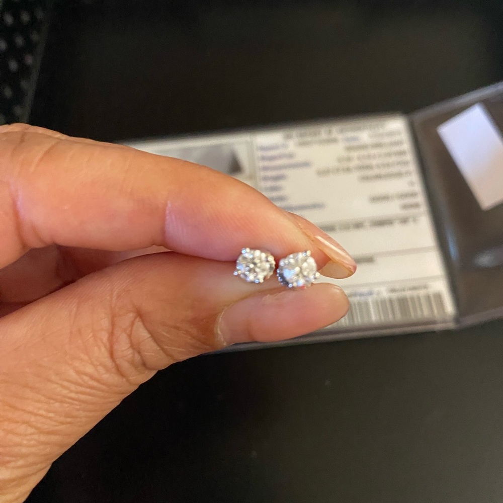 A pair of diamond earrings. Total 0.54 CTs. Report of Authenticity included.